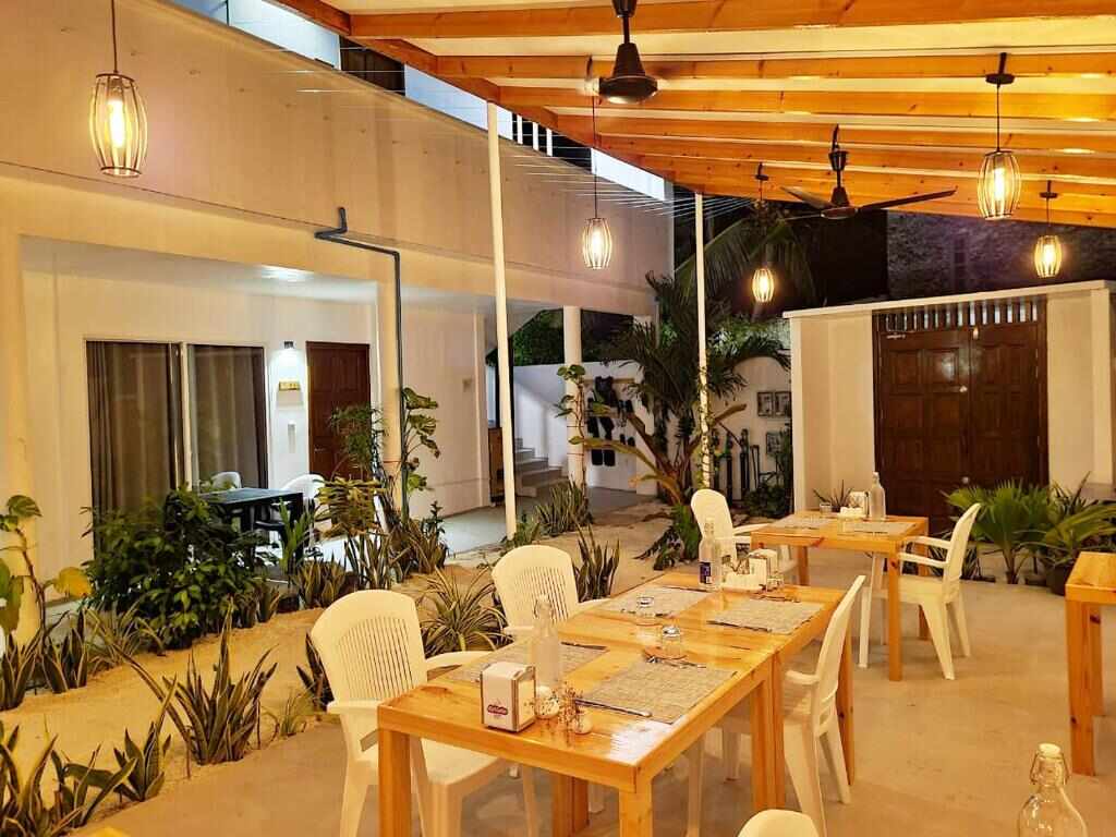 Open air restaurant and garden dining area at Dhonkamana Stay